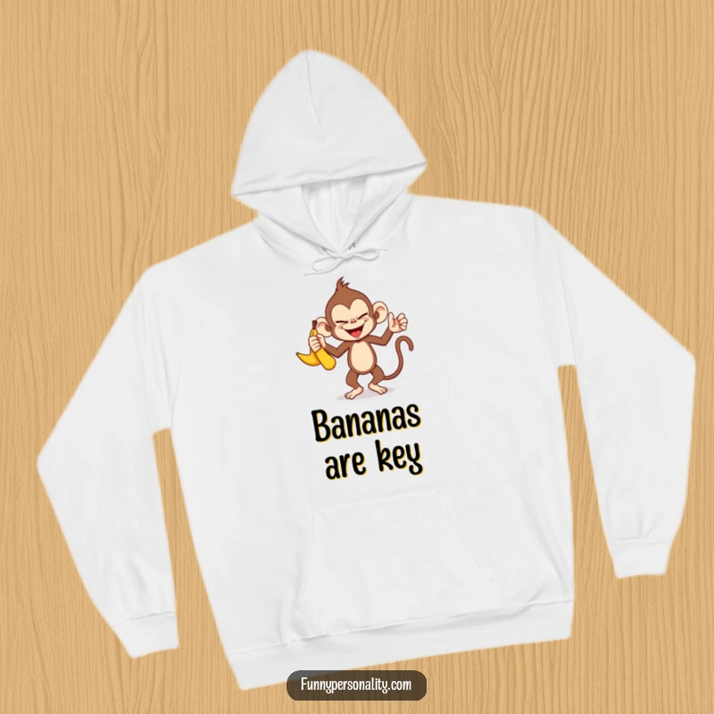 Funny monkey hoodie: a warm hoodie featuring a mischievous monkey character juggling three bananas with a sly smile.