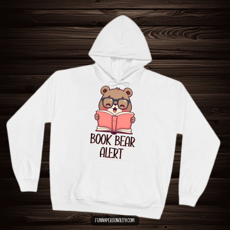 Funny hoodie featuring a cute bear in glasses, enthusiastically reading a giant open book, perfect for cozy reading sessions and study.