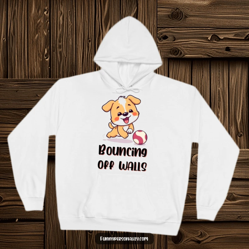 Funny hoodie featuring a playful dog character comically tripping while chasing a bouncing ball, perfect for dog owners.
