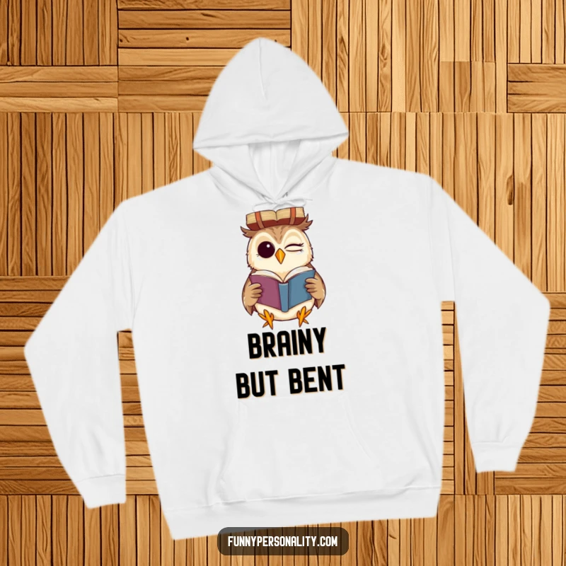 Funny hoodie with a winking owl grinning while reading a book upside down, a cozy and humorous statement for book lovers.