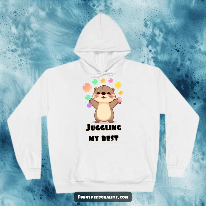Funny Otter Hoodie showcasing a happy otter juggling luminous orbs, offering warmth and vibrant cheer.