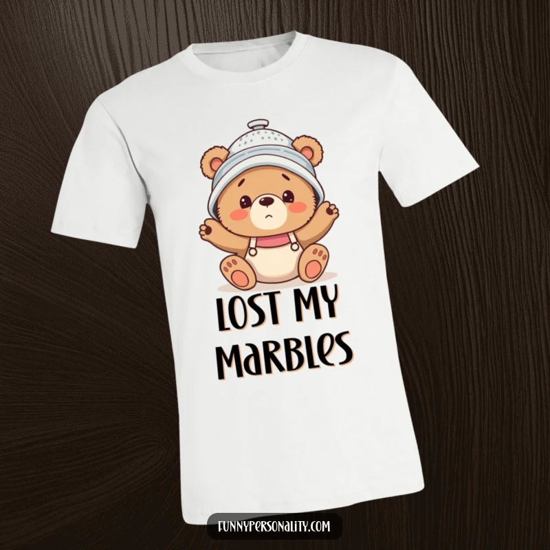Funny T-Shirt depicting a clumsy bear cub with a colander on its head, expressing comical confusion and charm.