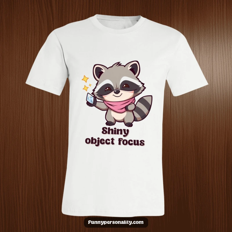 Funny T-Shirt: A joyful raccoon in a mask gleefully clutching a shiny object, radiating playful mischief and a spirit of adventure.